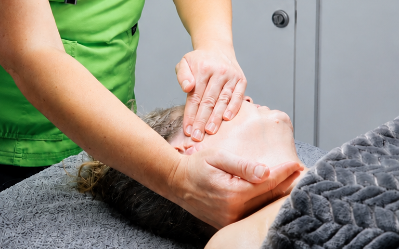 a therapist is carrying our buccal sculpting massage and is working on the neck